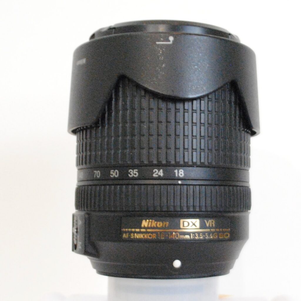 Nikon AF-S DX NIKKOR 18-140 F/3.5-5.6G ED on white background
