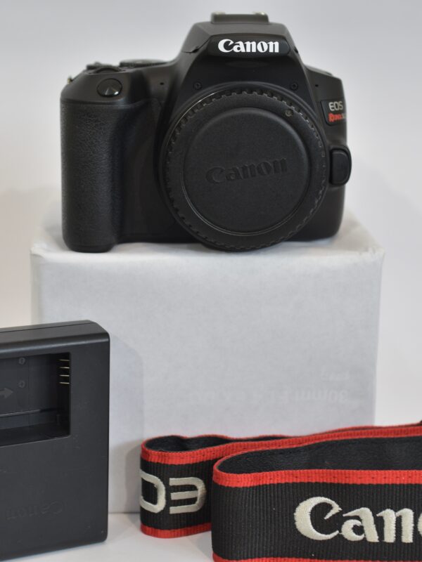 Used Canon EOS Rebel SL3 camera body with Canon EF-S mount, body cap, and strap