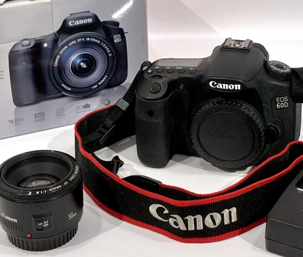 Used Canon EOS 60D camera with Canon EF 50mm f/1.8 STM lens, strap, charger, and battery